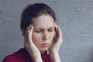 Young woman suffering from headache