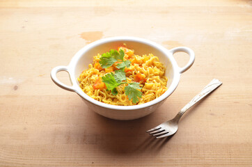 Maggi on white bowl wooden background
