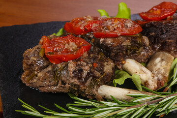 Baked elk meat with tomatoes