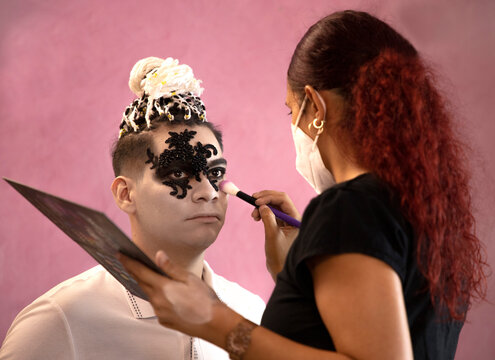 Makeup Artist With A Mask Putting Makeup On A Man For Halloween