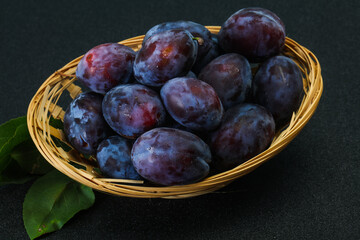 Ripe plum heap in the basket