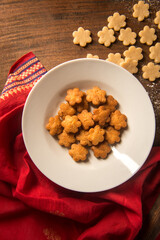 Shankarpali or Shakkarpara- a deep fried sweet snack made during special occasions like Diwali. Top view of fried sweet Shakkarpara.