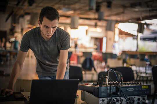 Behind the scene. Sound technician electric engineer adjusting sound elements backstage. Control audio panel. Audio mixing console