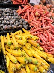 Different color carrots for sale in supermarket. Yellow, red, black or purple carrots.