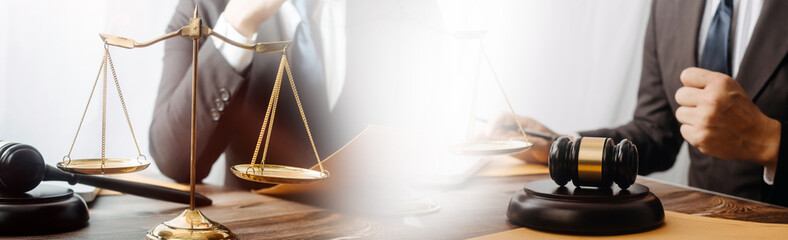 Justice and law concept.Male judge in a courtroom with the gavel, working with, computer and...