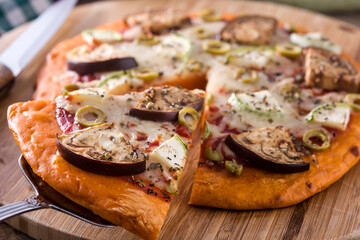 Autumn pumpkin pizza with vegetables on wooden table.	