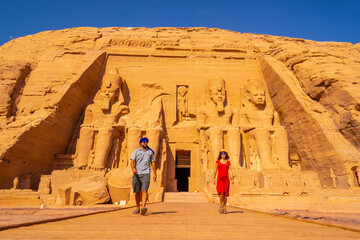 A tourist couple visiting the Abu Simbel Temple in southern Egypt in Nubia next to Lake Nasser....