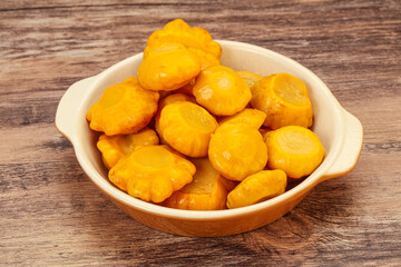 Marinated yellow patisson in the bowl