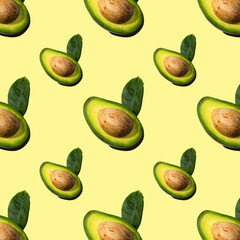 Seamless pattern of half avocado with bone and leaf, shadow. Healthy vegetarian food, background for design.