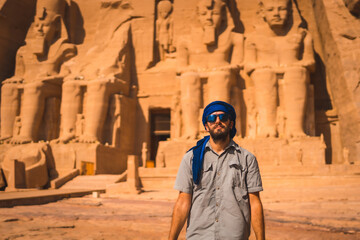 A young tourist with a blue turban visiting the Abu Simbel Temple in southern Egypt in Nubia next to Lake Nasser. Temple of Pharaoh Ramses II, travel lifestyle