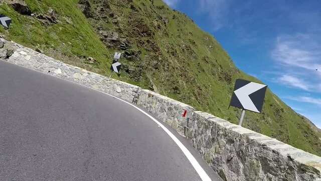 Curves driving up the Stelvio Pass by motorcycle along cyclists driving up the mountain road. Includes three different video sequences!