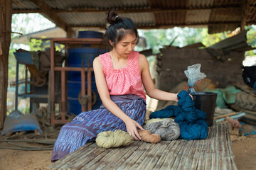 Young Asia women dyeing fabric cotton from natural ingredients