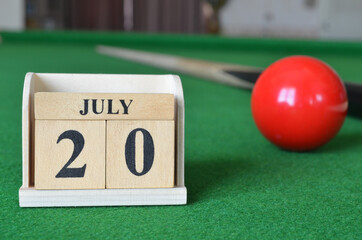 July 20, number cube with balls on snooker table, sport background.