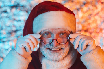 Portrait of Santa Claus in eyeglasses staring at you and smiling
