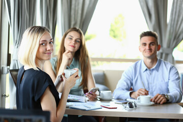 Business meeting in a cafe young businessmen