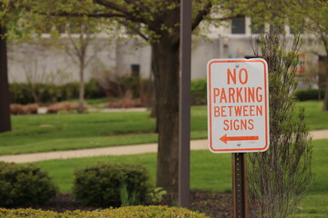 Road sign on the background of urban greenery