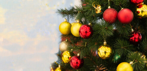 Obraz na płótnie Canvas New year banner. Bright Christmas tree with glass yellow and red balls
