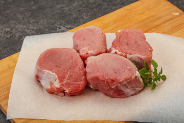 Raw pork medallion served rosemary