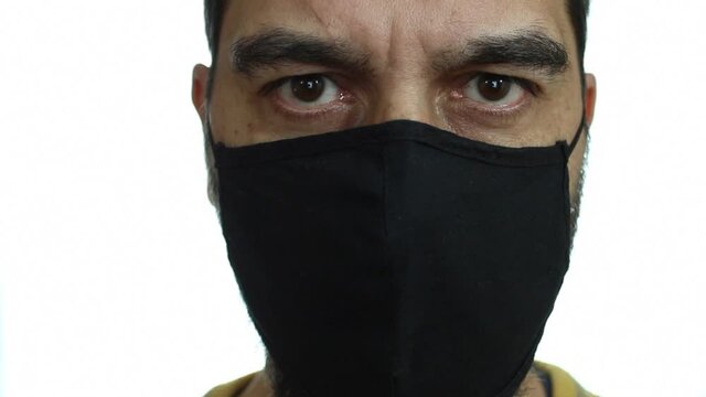 Close-up, man wears a black cotton mask to protect himself from Covid 19