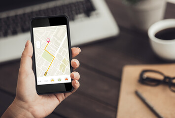 Businesswoman Booking Taxi Online Via Mobile App Sitting In Office