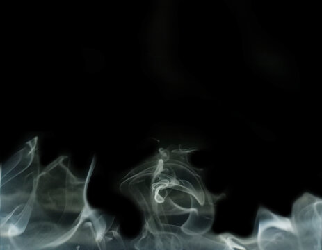 Abstract white motion smoke on black background with free copy space.