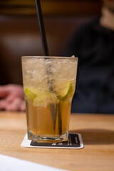  cocktail with straw stands on a wooden table