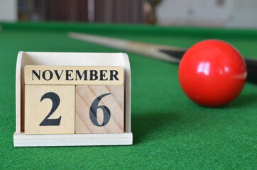 November 26, number cube with balls on snooker table, sport background.