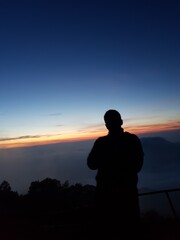 silhouette person at mountain sunrise 