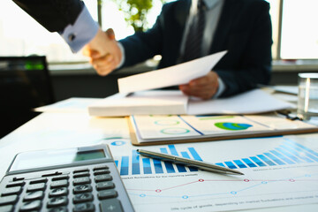 Businessman in sut hand shake in ofiice closeup. Introduce manager job man risk chart paper how...