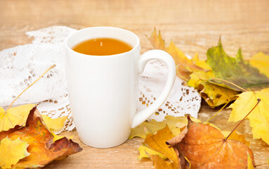 Naklejka na ściany i meble Cup of tea with autumn leaves