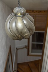 Close up interior view of very old vintage dusty lamp in silver color. Home interior backgrounds.