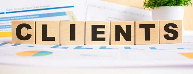 CLIENTS the word on wooden cubes. Background is a business diagram. Business and finance concept