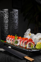 Japanese traditional rolls with tuna, caviar, on a dark table
