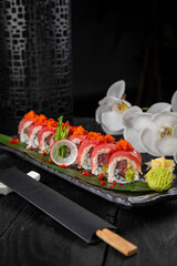 Japanese traditional rolls with tuna, caviar, on a dark table
