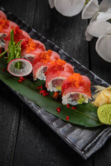 Japanese traditional rolls with tuna, caviar, on a dark table
