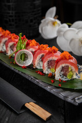 Japanese traditional rolls with tuna, caviar, on a dark table
