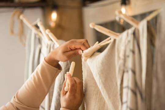 Close up female shop owner hanging fabric