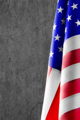 Vertical photo of a US flag on concrete background. Background for creating a postcard or...