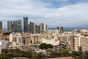 Vibrant urban skyline of Beirut, a Mediterranean coastal city featuring modern high-rise buildings, luxury apartments, and commercial towers contrasting with Beirut's classical buildings	