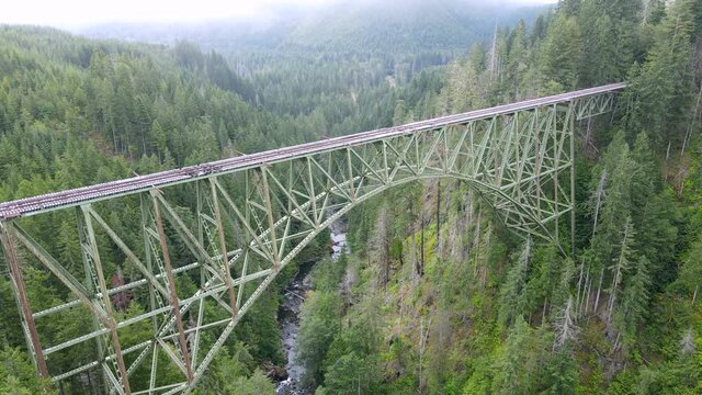 Passing over the abandoned rail bridge crossing and a rugged forest canyon, Vance Creek, Washington