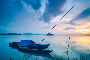 The boat is anchored at Tri An lake on an early morning, Dong Nai province, Vietnam.