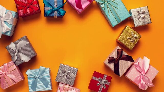 Gift boxes moving  on  yellow background.Holiday and celebrating concept.Stop motion video.	
