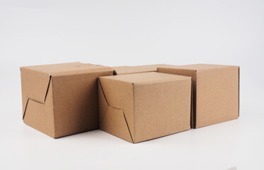 several cardboard boxes. Cardboard Boxes Stacked Against White Background