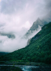 Photo of mountains in the fog in a classic style.