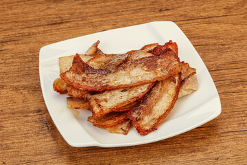 Roasted juicy bacon in the plate