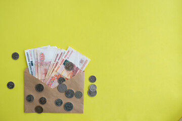 On a yellow background, an envelope with money, Russian five thousandth rubles. Economy concept,...