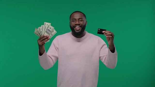 black man shows cash or credit card. money banknotes and card, african american man guy in casual with success in cash financial freedom on Green Screen, Chroma Key