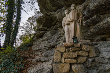 Holy stone statue in the Brother Klaus grotto at Beuron Monastery in the Danube Valley in autumn