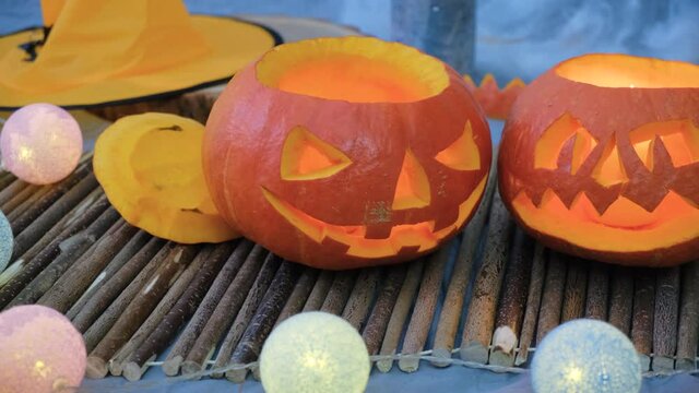 Two carved pumpkins with candles and decoration for Halloween