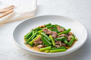 Stir fried onion flower Stem and sliced pork with oyster sauce